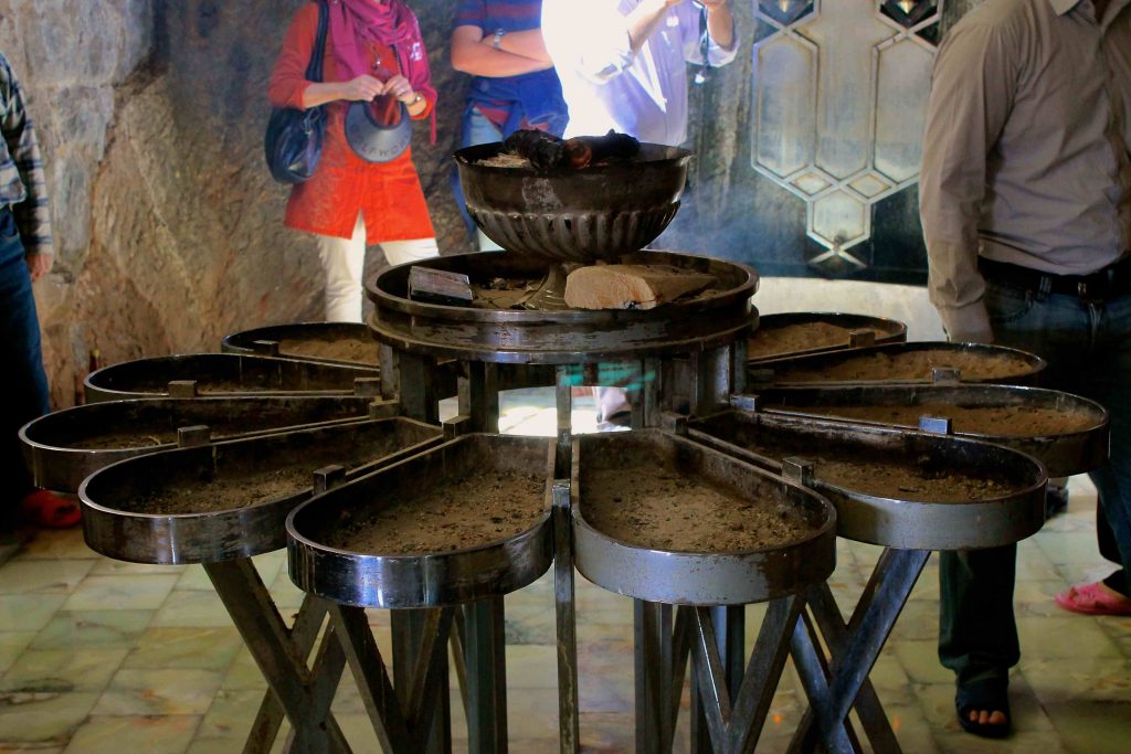 The flower shaped brazier (“manqal”) in the middle of the shrine consists of twelve petals, each representing a month of the year. The fire coals at the top usually sizzle and are kept hot; however, the full fire is only lit during times of worship and on holy days.