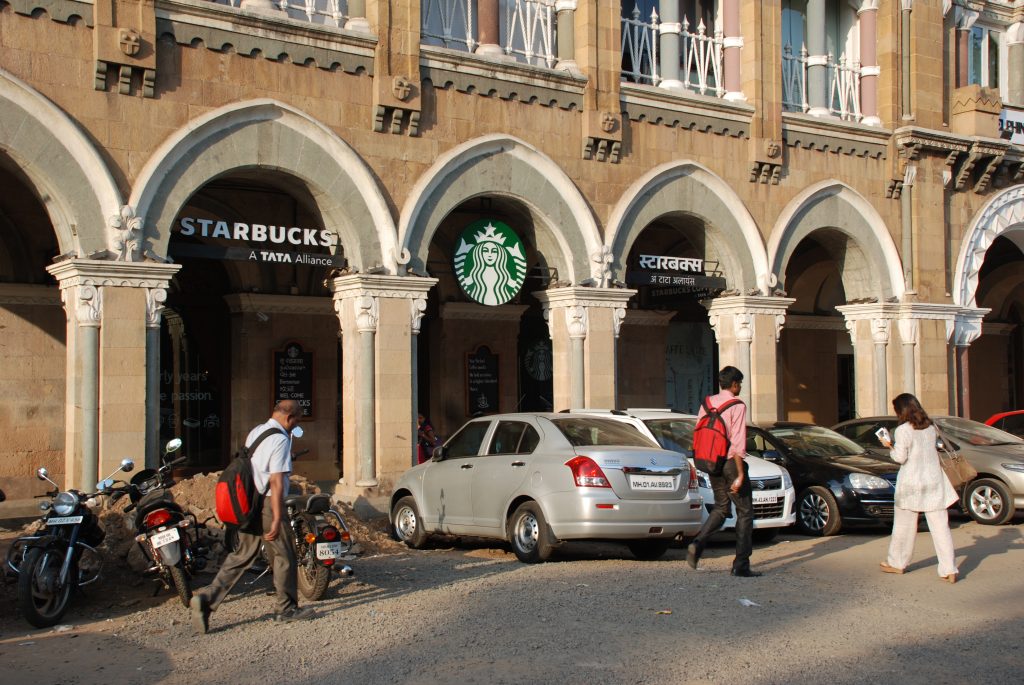 Mumbai Starbucks emblazoned with the logo of TATA, one of the world's largest companies that was founded and is still by local Parsees.