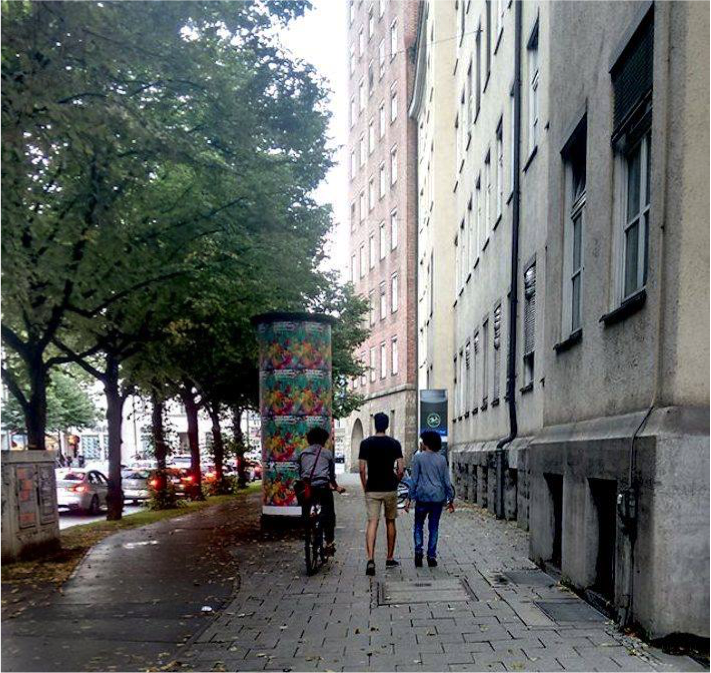 Three young men of Iranian heritage chatting whilst enjoying a stroll through the streets of Munich.